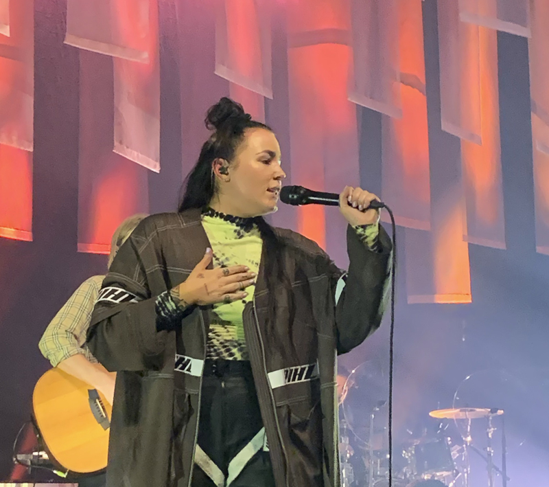 Miriam tar handen på bröstkorgen och sjunger.