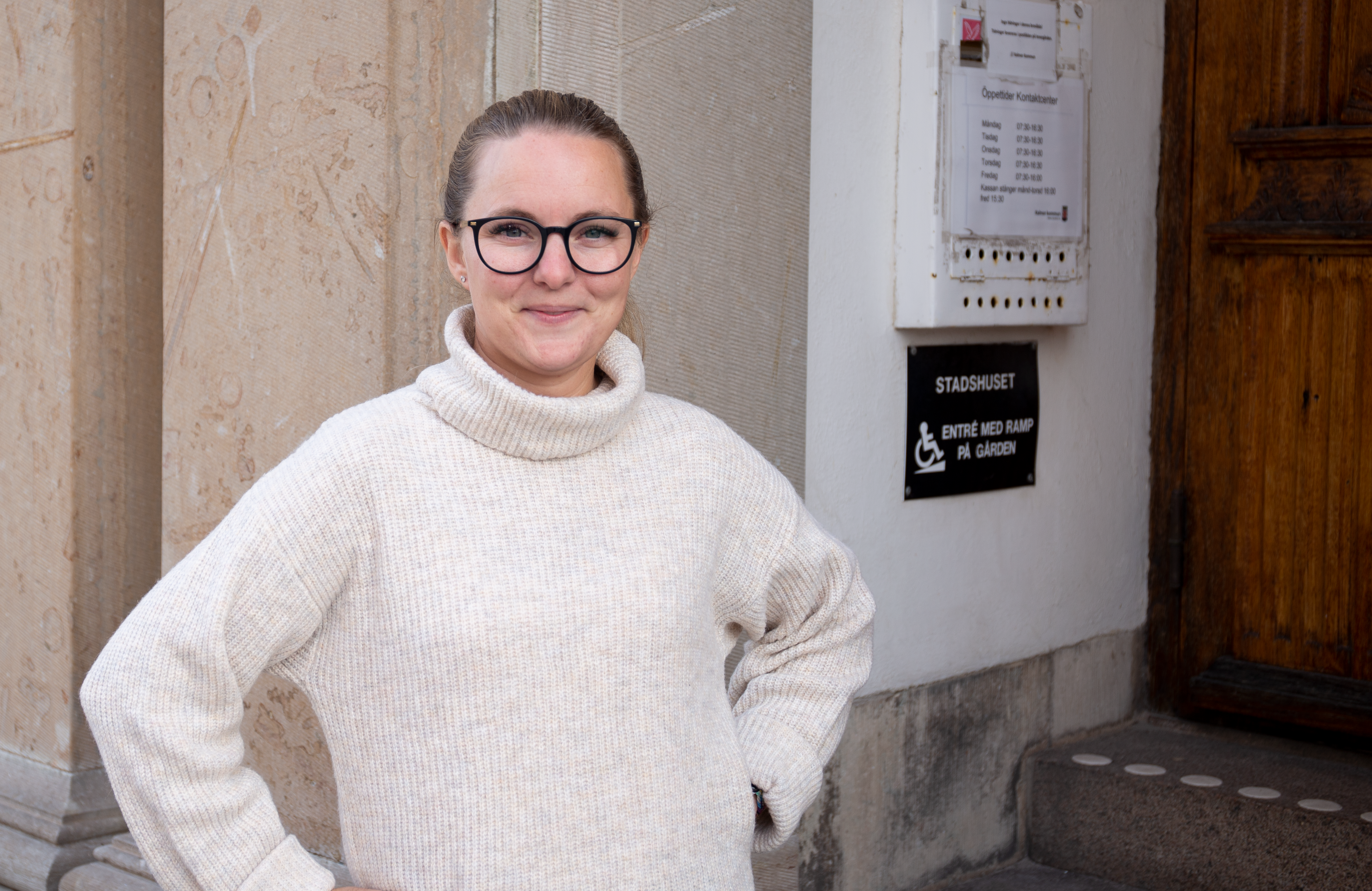 Bild på Elisabeth Heimark Sjögren när hon stolt poserar utanför stadshuset i Kalmar.