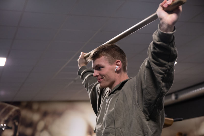 Dante Jacobsson värmer upp med en pinne bakom nacken.