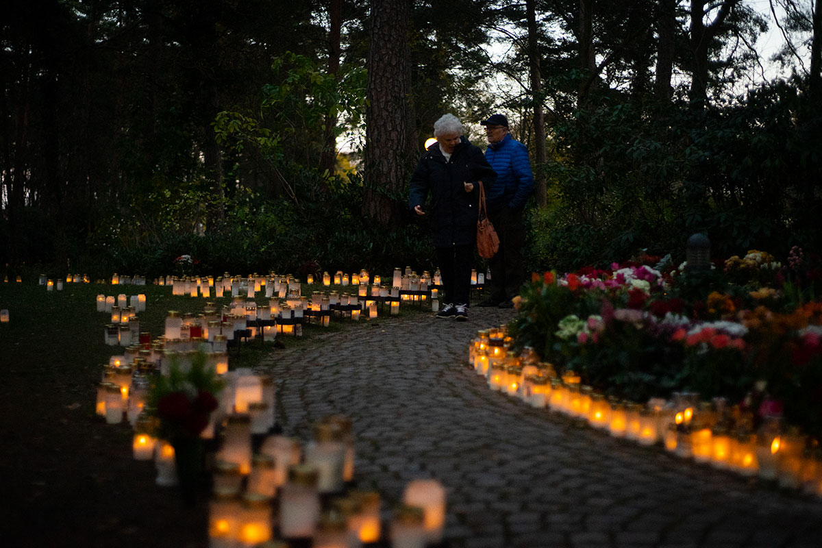 Äldre par tittar ut över Norra kyrkogårdens minneslund.